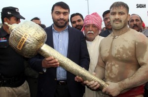 Director General Sports Punajb, Usman Anwar awarding Gurz to the winner of Sher-e-Punjab Dangal, Umair Pehlwan in Lahore on Friday.