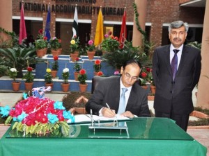 NAB Chairman, Qamar Zaman Chaudry writing his comments after chairing a meeting to review performance of NAB Lahore during annual inspection on Friday.
