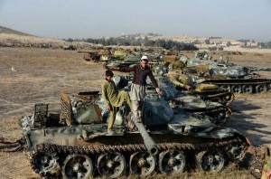Afghan children are playing onthe armoured vehicle abandoned in the suburb  of Jalalabad since Soviet invasion era.-AFP