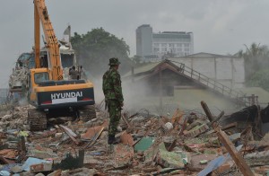 An Indonesian militaryman is deployed in the red light area where old buildings are  being demolished in Jakarta.-AFP 