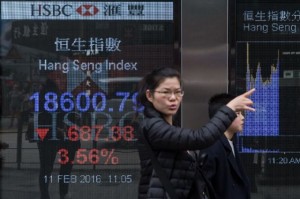  A lady pointing to Hang Seng Index during a display in Hong Kong on Thursday.