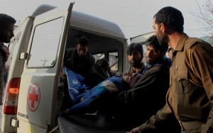 Kashmiris are rushing  a person injured in a clash to a local hospital in Srinagar.