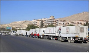 A convoy of humanitarian aid waiting in front of the United Nations Relief and Works Agency (UNRWA) offices before making their way into the government besieged  rebel-held towns of Madaya, al-Zabadani and al-Moadhamiya in Damascus  countryside, Syria on Wednesday.
