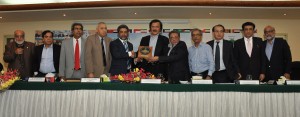 Chairman Businessmen Group & Former President KCCI Siraj Kassam Teli and President KCCI Younus Muhammad Bashir presenting Chamber's crest to Advisor to Prime Minister for Revenue, Haroon Akhter during his visit to KCCI on Saturday.