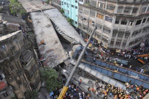  Locals and rescue workers clearing rubble of a partially collapsed overpass in Kolkata on Thursday.