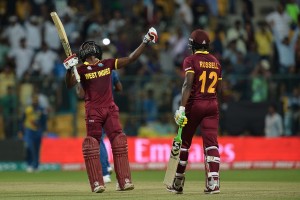 West Indies batsmen Andre Fletcher (L) gestures after winning the match with 84 not out while his partner Andre Russell looks on during the World T20 cricket tournament match between West Indies and Sri Lanka at The Chinnaswamy Stadium in Bangalore on March 20, 2016. / AFP / Kiran MANJUNATH        (Photo credit should read KIRAN MANJUNATH/AFP/Getty Images)