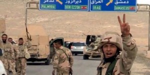 Forces loyal to Syrian President Bashar al-Assad gesture as they advance into the historic city of Palmyra on Thursday. 