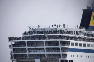 Refugees and migrants are seen on board the Eleftherios Venizelos passenger ferry as they are transferred to the Greek mainland, following their departure from the port of Mytilene on the Greek island of Lesbos on Sunday.