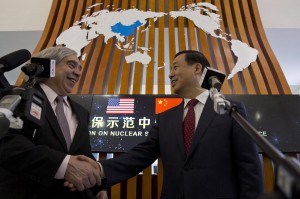 U.S Energy Secretary Arnest Moniz shaking hand with Chairamn of Chinese Atomic Energy Organisation during a meeting in Beijing.-AFP