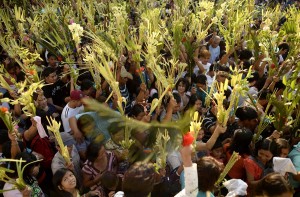 Roman Catholics waving date palms during Palm Sunday service in Manila on Sunday.