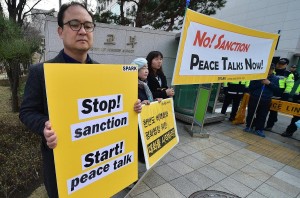 South Korean anti-war activists holding placards aganist South Korea-U.S. high level talks for sanctions against North Korea in Seoul. -AFP