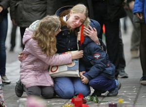 A woman consoles her children at a street memorial following the bomb attacks in  Brussels, Belgium.-REUTERS