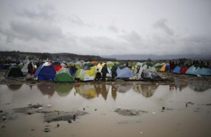 Migrants walk in a mud at a makeshift camp on the Greek-Macedonian border  near the village of Idomeni, Greece on Thursday.