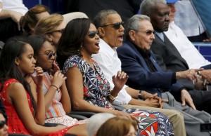  President Obama and his family react along with Cuban President Raul Castro to an exhibition game between the Cuban National team and the MLB Tampa Bay Rays at Estadio Latinoamericano in Havana.-REUTERS