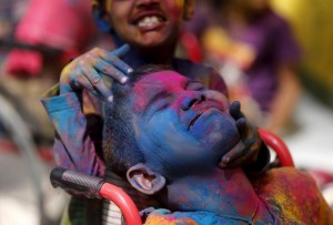 Disabled children cover each other in coloured powder during Holi celebrations in  Mumbai, India.- REUTERS