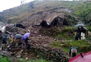 Local people and members of a welfare organisation are engaged in relief activities  after a landslide hit two houses in Lelonai, Bisham.