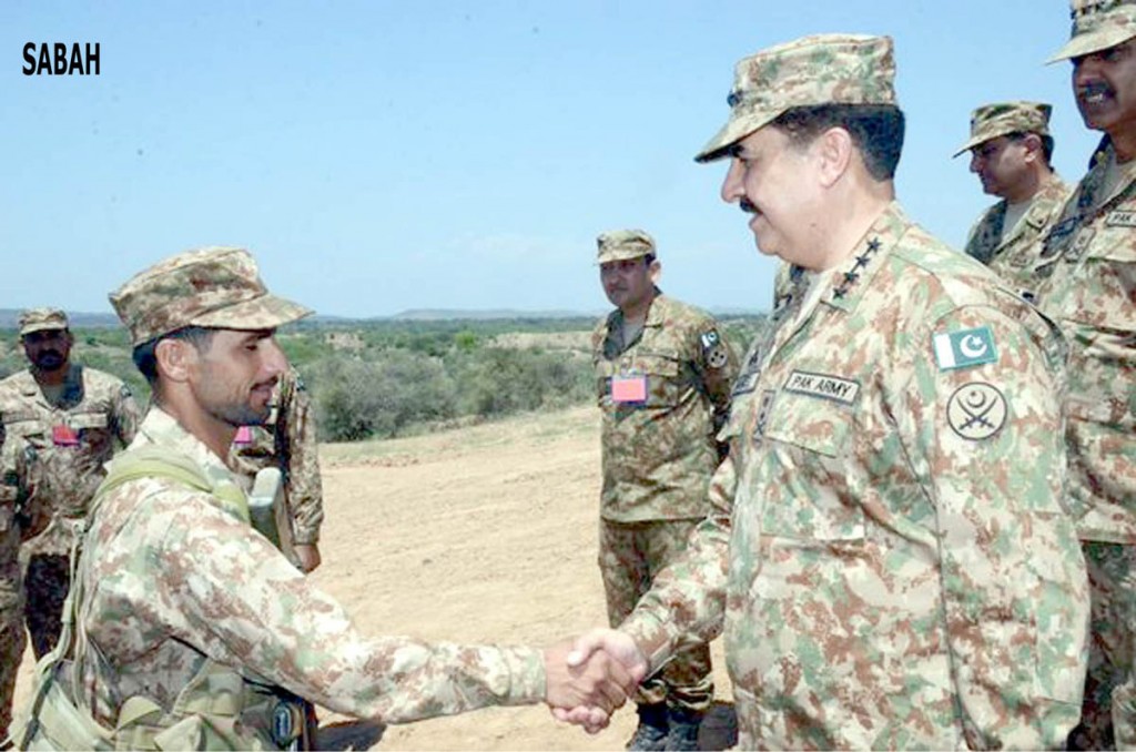COAS shaking hand with a soldier during his visit to Manoeuvre exercise of 30 Corps near Jhelum on Thursday. - SABAH