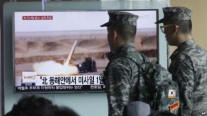 South Korean Army soldiers pass by a TV news programme showing a file footage of a  missile launch conducted by North Korea at Seoul Railway Station in Seoul on Friday.