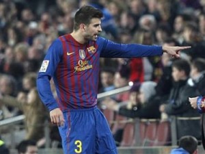 Barcelona's Gerard Pique leaves the pitch after being sent off during their Spanish first division soccer match against Sporting de Gijon at Nou Camp stadium in Barcelona March 3, 2012. REUTERS/Albert Gea