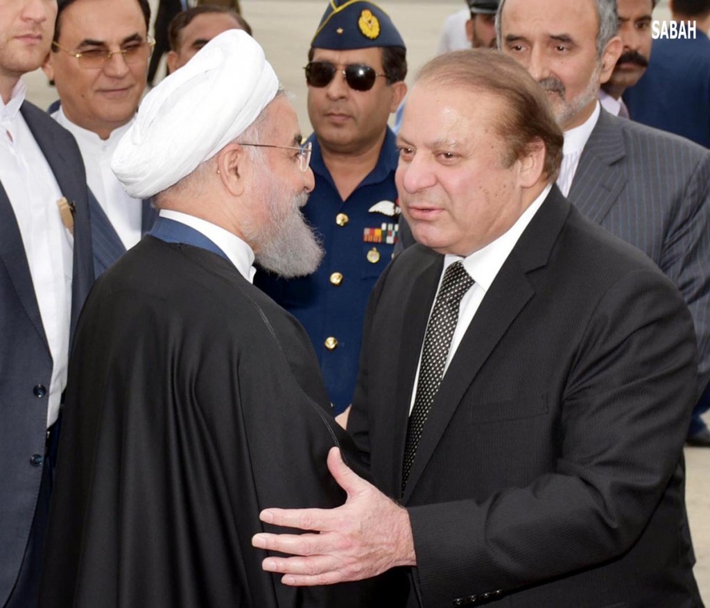 Prime Minister Muhammad Nawaz Sharif receiving the President of Iran Hassan Rohani on his arrival at Nurkhan Airbase in Islamabad on Tuesday.