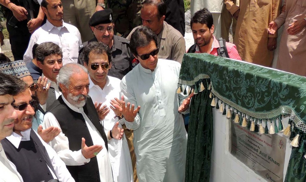 Chairman PTI Imran Khan offering dua after inaugurating mini-micro Hydel Project in Battagram. - NNI