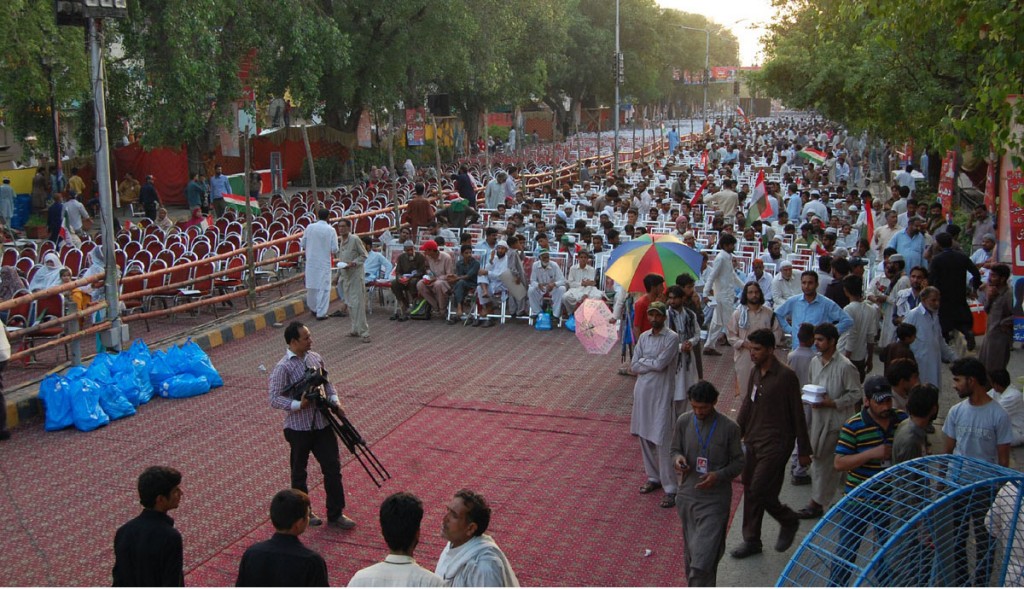 PAT activists await their leader Tahirul Qadri at PAT sit-in protest outside of Punjab Assembly in Lahore on Friday. - DNA