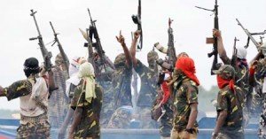 Fighters with the Movement for the Emancipation of the Niger Delta (MEND) raise their riffles to celebrate news of a successful operation by their colleagues against the Nigerian army in the Niger Delta on September 17, 2008. MEND has declared a full-scale "oil war" against the Nigerian authorities in response to attacks by the Nigerian military launched against the militants. "Our target is to crumble the oil installations in order to force the government to a round table to solve the problem once and for all", said Boy Loaf, leader of the militants. AFP PHOTO/PIUS UTOMI EKPEI (Photo credit should read PIUS UTOMI EKPEI/AFP/Getty Images)