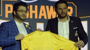 Pakistan Super League (PSL) team Peshawar Zalmi captain Shahid Afridi (R) takes team shirt during second edition of Pakistan Super League (PSL) draft in Dubai on October 19, 2016. Pakistan's Twenty20 league boss Najam Sethi on October 19 promised a bigger second edition with the final in Lahore in February-March next year, declaring perceptions were changing about the terror-hit country. Some 414 players were put in the draft with former New Zealand captain Brendon McCullum, West Indian Chris Gayle and Dwayne Bravo, Australia's Shane Watson, Bangladesh's Shakib Al Hasan and England's Twenty20 captain Eoin Morgan, Alex Hales and Jason Roy as star attractions. Five teams took part in the inaugural edition of the Pakistan Super League (PSL) -- on the lines of India's lucrative league started in 2008 -- held in Dubai and Sharjah in February-Marach 2017. / AFP / AAMIR QURESHI        (Photo credit should read AAMIR QURESHI/AFP/Getty Images)
