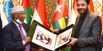 Minister of State for Information and Broadcasting Farrukh Habib, presenting a photo album to Secretary-General of the Organization of Islamic Cooperation (OIC), H.E. Hissein Brahim Taha of his visit to Pakistan.