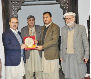 KPK Secretary Information & Public Relations, Arshad Khan is presenting a shield to Department's Deputy Secretary, Obaidullah on his farewell Party on Monday.