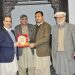 KPK Secretary Information & Public Relations, Arshad Khan is presenting a shield to Department's Deputy Secretary, Obaidullah on his farewell Party on Monday.