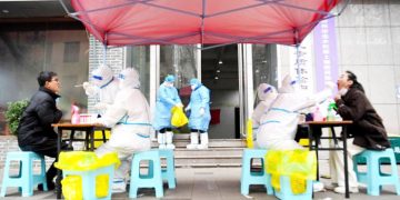 Medical workers take swab samples from citizens for nucleic acid test  at a COVID-19 testing site in Zhengzhou, central China’s Henan Province