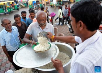 People get food from a social worker during the World Food Safety  Day in Agartala, the capital city of India’s northeastern state of Tripura
