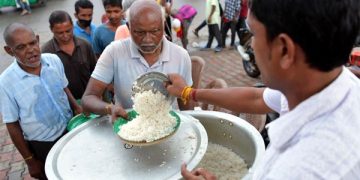People get food from a social worker during the World Food Safety  Day in Agartala, the capital city of India’s northeastern state of Tripura