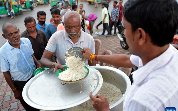 People get food from a social worker during the World Food Safety  Day in Agartala, the capital city of India’s northeastern state of Tripura